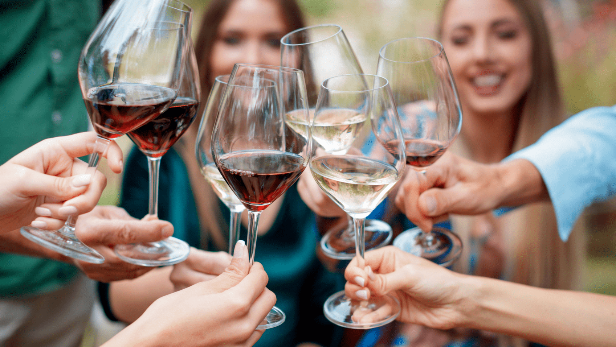 Friends cheersing red and white glasses of wine