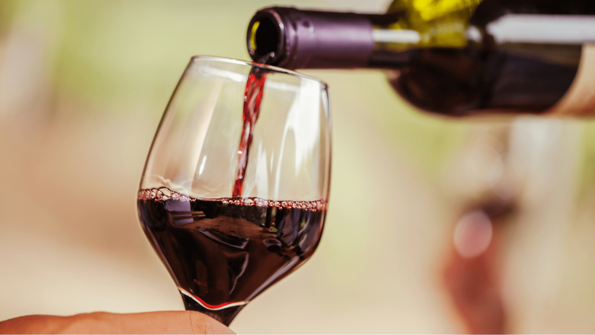 Red wine poring into a glass