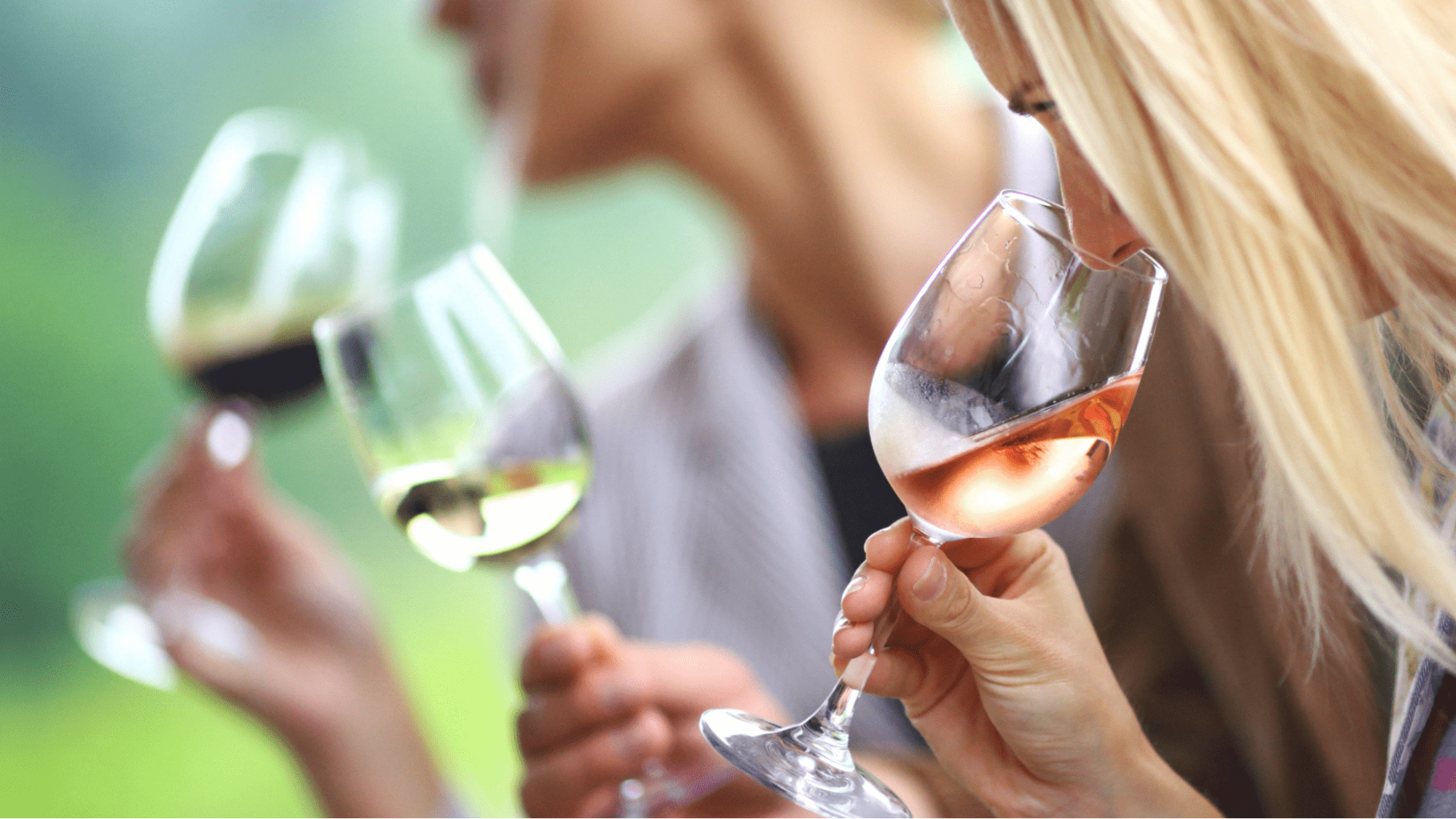 A woman smelling wine