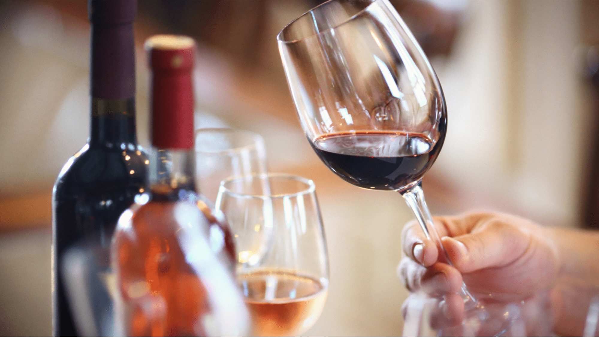 Tilting red wine glass